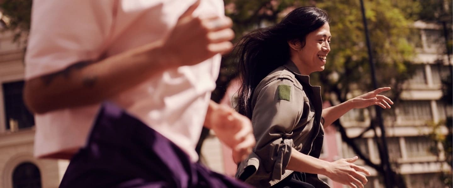 Mujer con chamarra verde militar corre entre un grupo de gente: Nu aparece en el listado CNBC Disruptor 50